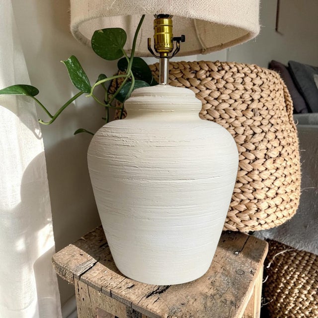 Illuminate your space with the Post Modern Alsy Textured Plaster Ginger Jar Lamp, a stunning blend of contemporary design...