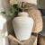 Illuminate your space with the Post Modern Alsy Textured Plaster Ginger Jar Lamp, a stunning blend of contemporary design...