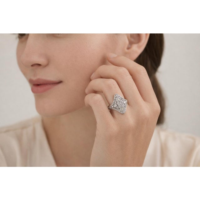 Elegant 14K white gold filigree ring featuring 3 round brilliant natural diamonds totaling 0.14 Carat Total Weight, graded...