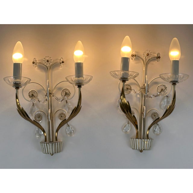 Set of two exceptional, large, elegant and highly decorative mid-century modern brass sconces or wall fixtures. Designed &...