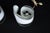 Elegant and sculptural, these lamps feature thick, curved white Murano glass shades with a smooth, flowing silhouette. The...