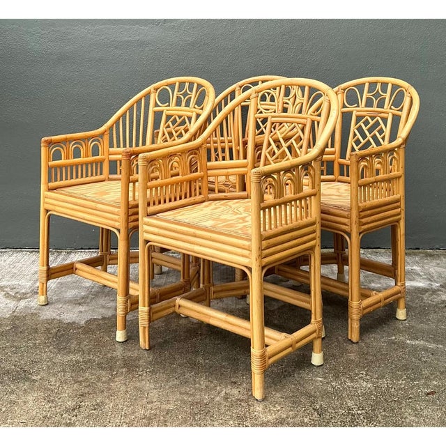 This set of four vintage Brighton Pavilion dining chairs brings Regency-era chinoiserie to life in natural rattan. Each...