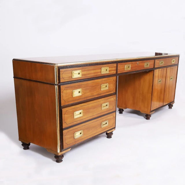 Standout vintage desk or credenza crafted in mahogany and satinwood with multiple components having a wide profile with...