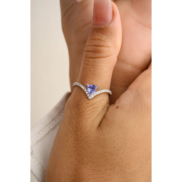 This is part of Chairish’s Fine Jewelry assortment. This exquisite ring features a trillion-cut tanzanite, dazzling with...