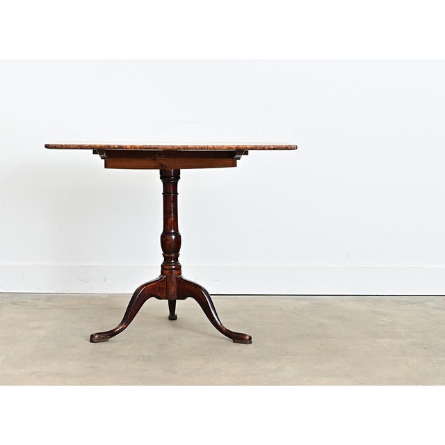 A magnificent tilt-top table from Sweden, mid-late 19th century. The square top features a dazzling patchwork of burled...