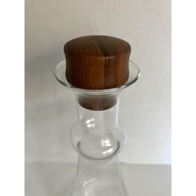 Here is a modern and beautifully designed glass decanter with a teak stopper, that was made in Denmark. You can see the...