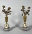 Pair of candelabra with vases of flowers. Chiseled bronze resting on white and blue Turquin marble bases. French work from...