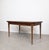 Rectangular Scandinavian-style dining table from around 1960. The satin teak veneer tabletop features a contrasting grain,...