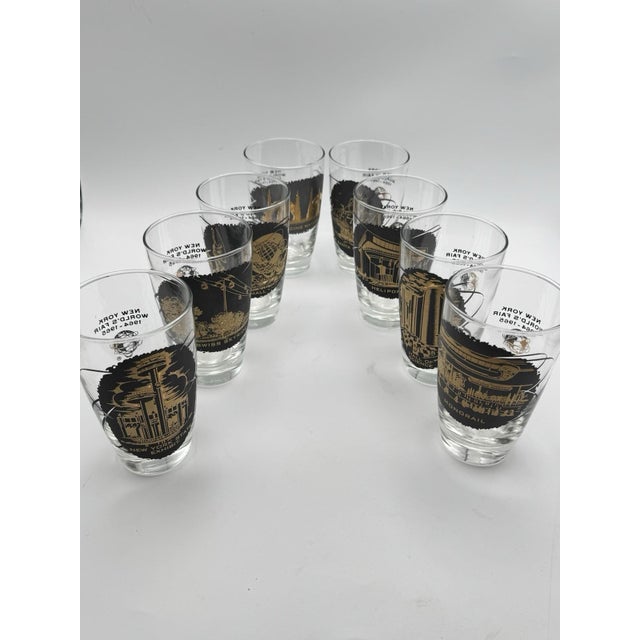 Set of 8 Vintage 1964–1965 New York World’s Fair Souvenir Glasses – Gold & Black Landmark Design A complete set of 8 mid-...