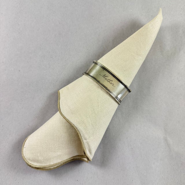 An oval sterling silver napkin ring engraved ‘Mother’ – circa 1900-1920. Heavy banding at top and bottom, script...