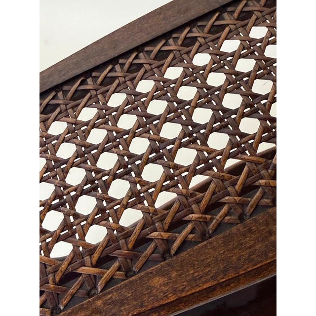 A beautifully preserved English Gothic Revival Canterbury bookcase, handcrafted from solid oak and finished in its...