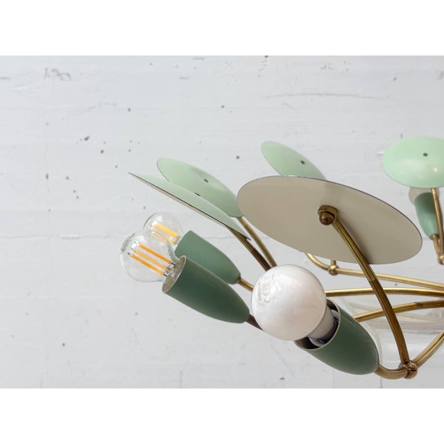 This mid-century chandelier dates from the 1950s and is designed in the style of Italian Stilnovo lighting. The lamp...