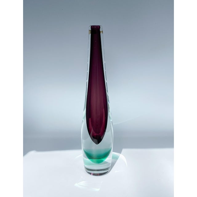 Signed glass bud vase by Norwegian artist Willy Johansson for the Hadeland Glassverk company. A deep purple amethyst color...
