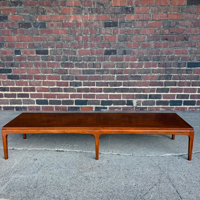 This is a lovely coffee table made by Lane Furniture Company. Style No 997-09 Serial No 261240. It features 6 softly...