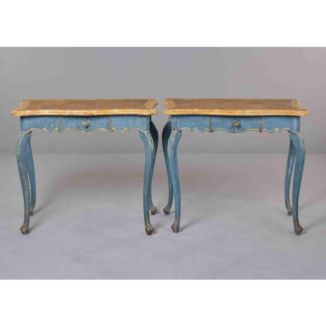 This pair of Italian Tuscan side tables features painted frames in a faded cerulean blue, accented throughout with hand-...
