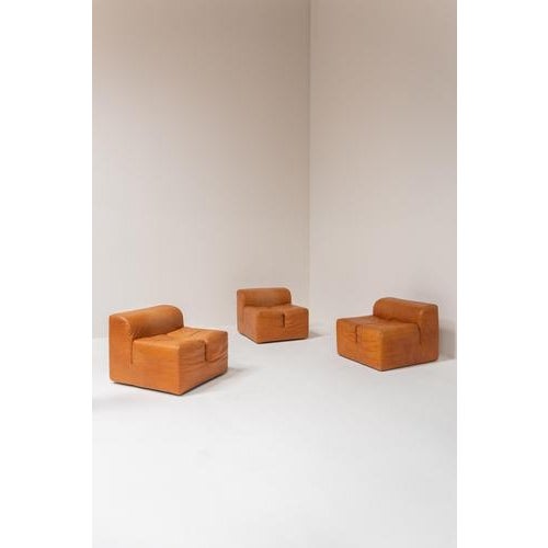 This set of Ipercubo lounge chairs comes in original cognac leather, showing a warm and natural patina that beautifully...