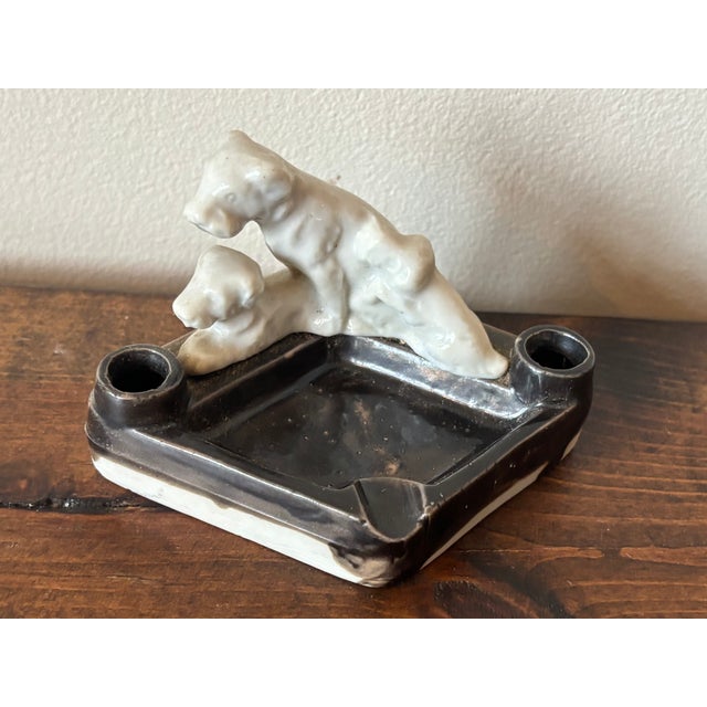 Vintage white and black ashtray with three dogs. Each end has a cigarette holder. A charming piece. Most items found at...