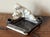 Vintage white and black ashtray with three dogs. Each end has a cigarette holder. A charming piece. Most items found at...