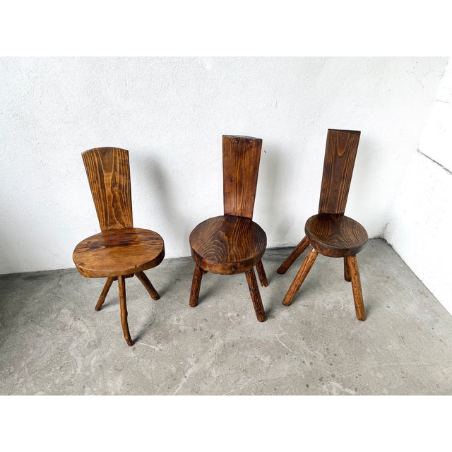 Trio of solid pine alpine chairs, France, 1950s. This type of handcrafted furniture, produced in limited editions and...