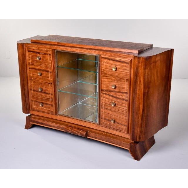 A sophisticated French Art Deco cabinet of exceptional quality, veneered in richly figured rosewood throughout with boldly...