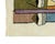 Striking hand-knotted wool rug featuring an abstract face design with accents in Olive Green, Dusty Pink, Burnt Orange,...