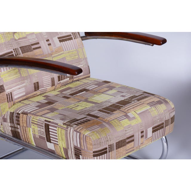 Professionally cleaned chrome Revived polish on the armrests New upholstery This piece is attributed to the mentioned...