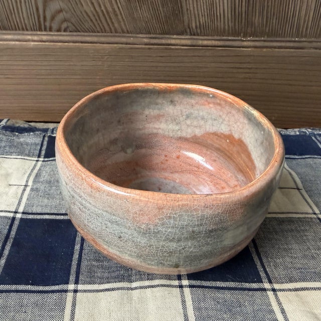This Japanese matcha chawan (Kyō-yaki / Kyo-ware) features a distinctive raku glaze: a soft, layered surface with subtle...