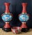 This vintage RARE set that includes 2 Mirrored Chinese Cloisonne Cinnabar lacquered Bud Vases with 2 wooden stands and a...