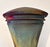 This handcrafted raku‑style ceramic vessel features a flared trumpet form with a narrow base, wide rim and mouth opening...