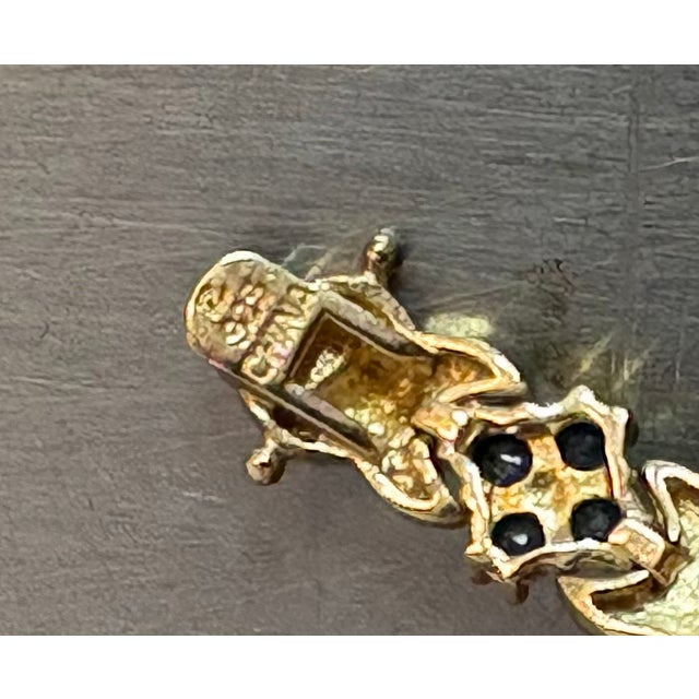 1950s-60s gold-tone sterling silver tennis bracelet w/ star clusters of diamonds, rubies, sapphires and emeralds. Marked...