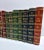 A curated set of 14 antique decorative books with red, green, blue, brown, and gilt bindings for instant library shelf...