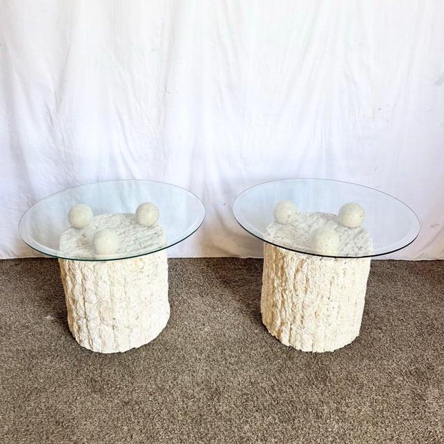 This striking pair of postmodern side tables features cylindrical tessellated stone bases topped with floating circular...