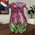 This vintage art glass vase features a two-tone design of cranberry and green, with a ruffled top adding a touch of...