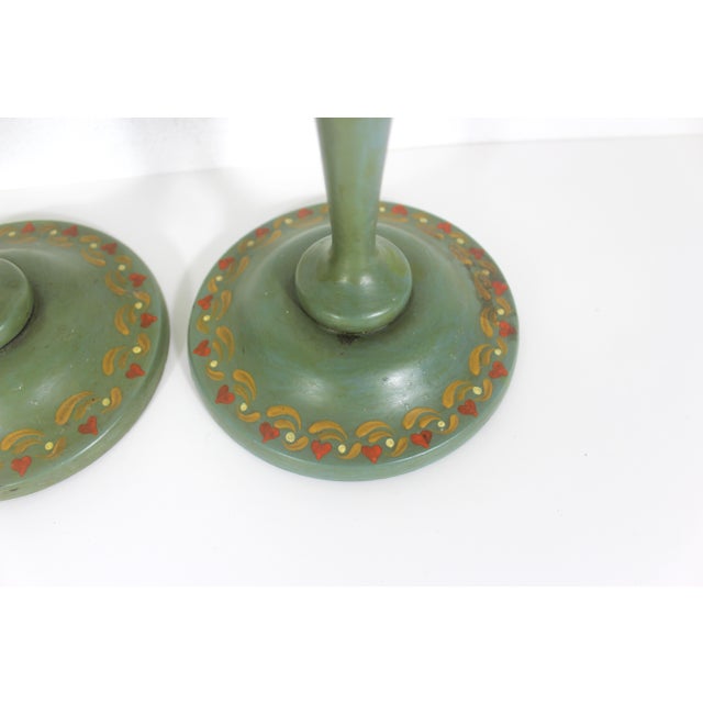 This is a gorgeous pair of antique, hand painted turned wood candle holders. The base colour is a sage green with hand...