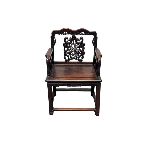 A stunning antique Chinese carved hardwood armchair showcasing exquisite Qing style craftsmanship. The backrest features...