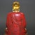 This striking figure depicts a seated enlightened being (likely a monk or arhat) in a meditative pose atop a golden lotus...