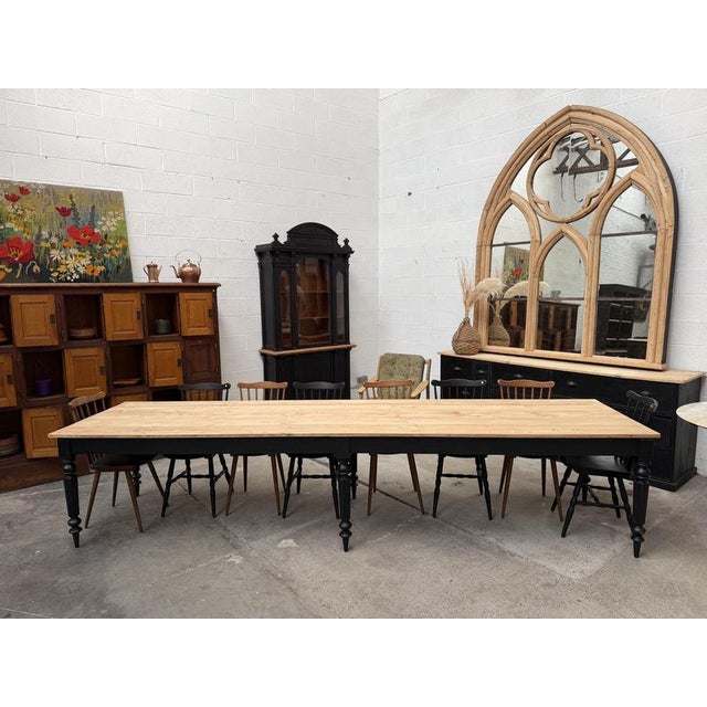 This massive fir table has been completely restored. It features a beautiful raw wood tabletop and a base with six legs...