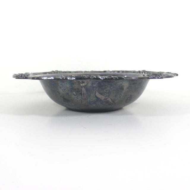 Beautiful silver plated bowl with a wide edge and raised fruit detail around the rim and heavy patina or tarnish, which...