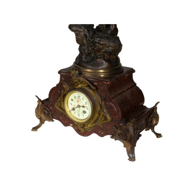 A Napoleon III mantel clock featuring a dynamic sculpture of a Revolutionary French peasant woman. Made from high-quality...