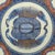 Japanese porcelain charger, c. 1820. The edge is gilded. The border is decorated with a diaper band. The body is decorated...