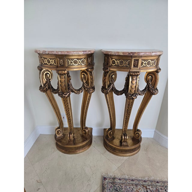 Pair of French Louis 16th Style Giltwood Rouge Marble Top Corner Tables sold as found dating from the 20th c.