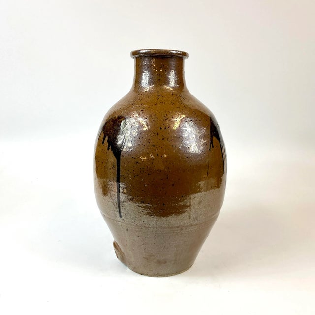 This brown ceramic Japanese jug is from the edo period (1603 -1868) and was likely used as a wine jug. The pictures are...