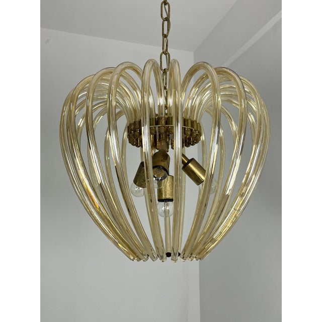 Mid-century four-light chandelier in Murano glass and brass in the style of Venini, 1960s The glass is intact, made of...
