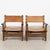 Pair of mid-century Spanish Brutalist club chairs, constructed with substantial dark oak frames and vintage cognac saddle...