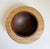 One-of-a-kind, handcrafted turned wood bowl featuring a burl maple lip and walnut bowl with three walnut feet. Unsigned.