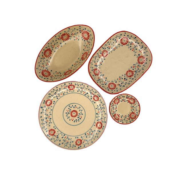 A beautifully collection of four handcrafted ceramic serving dishes from Bat Trang, Vietnam, featuring an intricate floral...