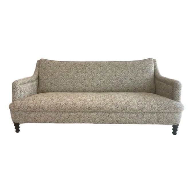 Beige fabric sofa with rolled arms