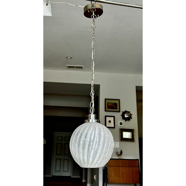 Single handblown Italian Murano globe or melon shape clear textured glass pendant ceiling light. Glass has eye catching...