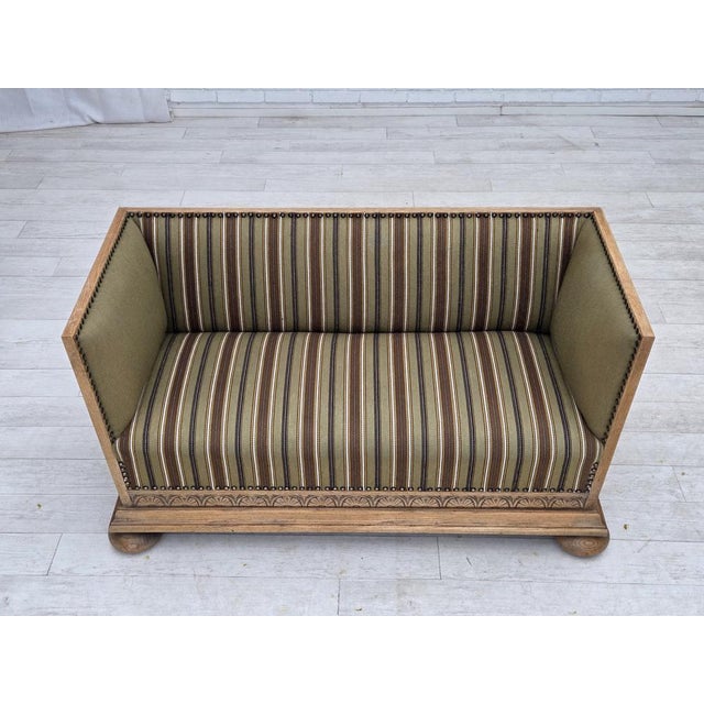 1950s, Danish 2-seater sofa. Original striped green furniture wool, oak wood legs, brass springs in the seat. Original...