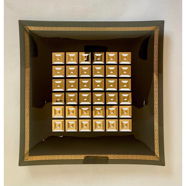 Here is a beautiful glass tray/trinket dish that features a smoky gray glass body with geometric gold detailing. It looks...